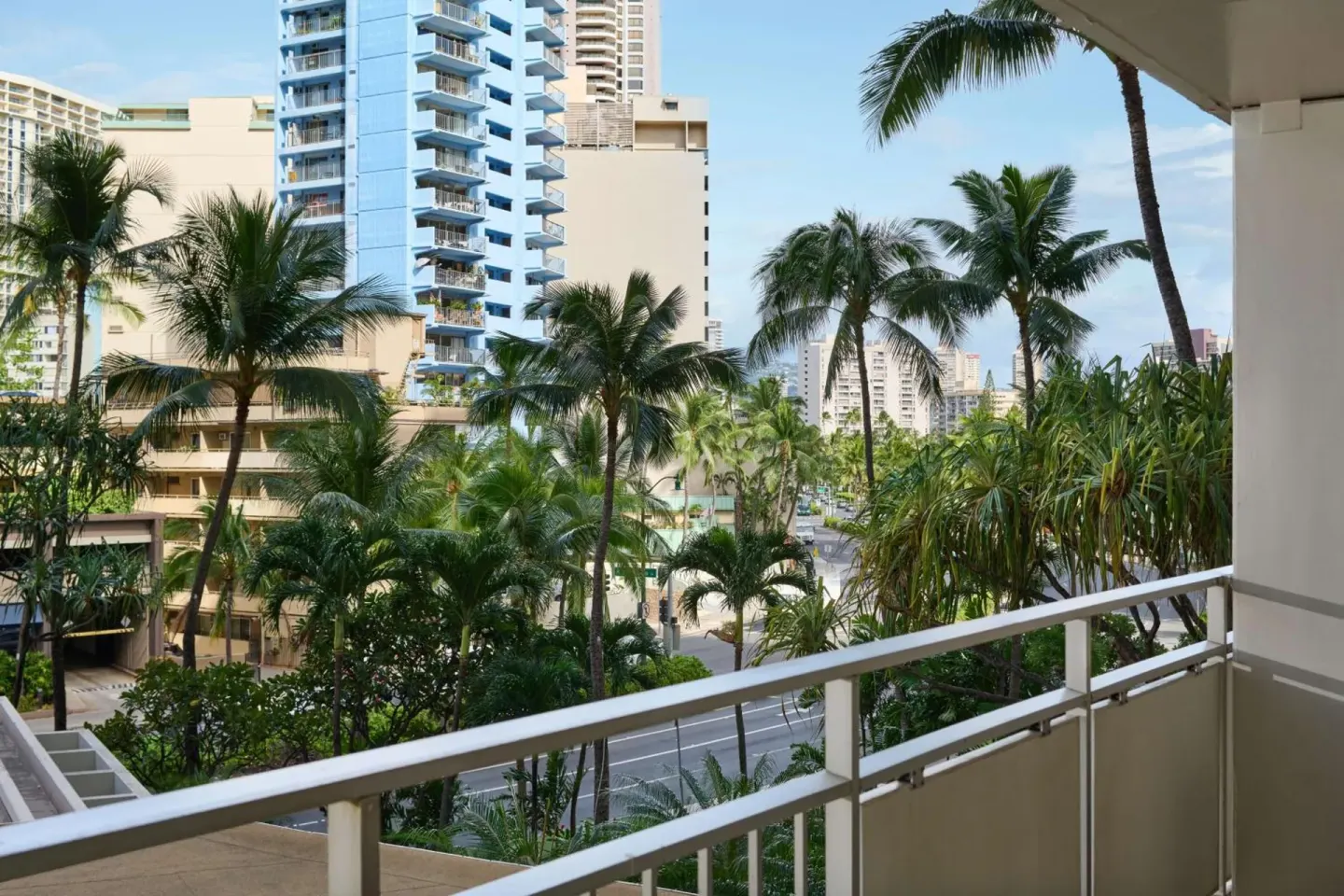 Balcony view of palm trees and nearby towers at Ilikai Hotel.