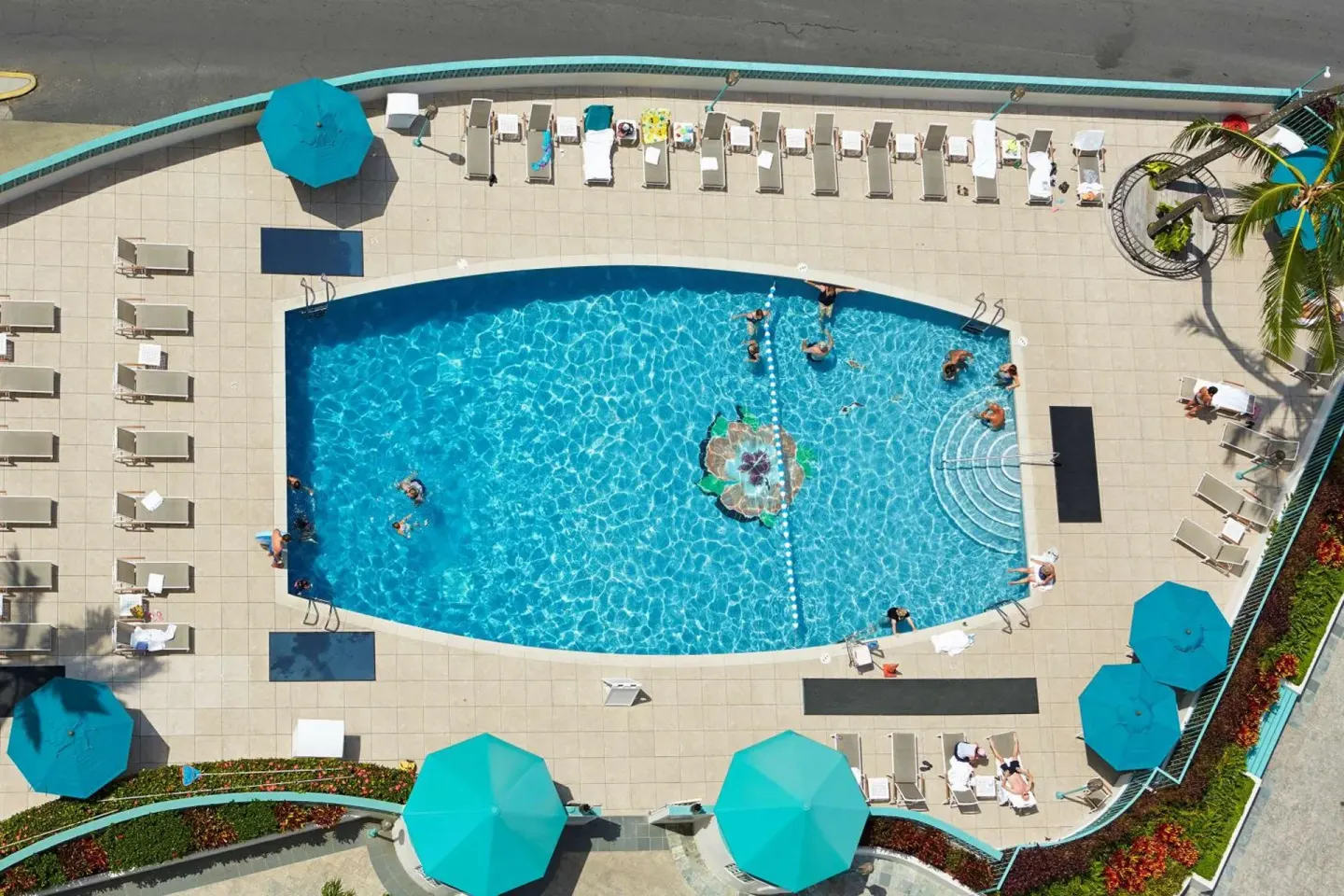 Overhead view of the pool deck with loungers and umbrellas at Ilikai Hotel.