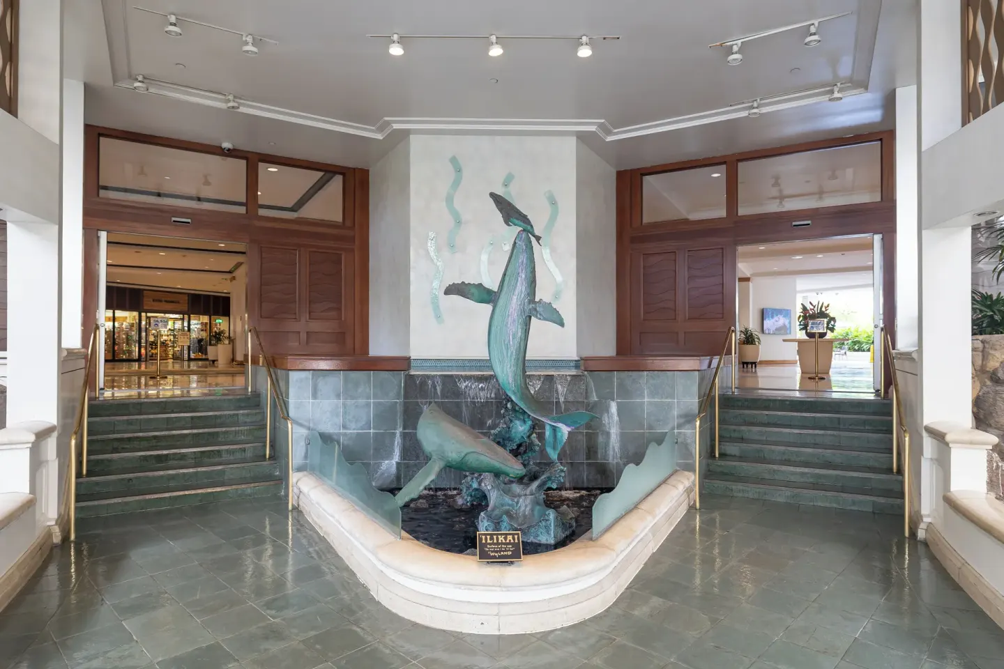 Whale sculpture fountain between stairways in the lobby at Ilikai Hotel.