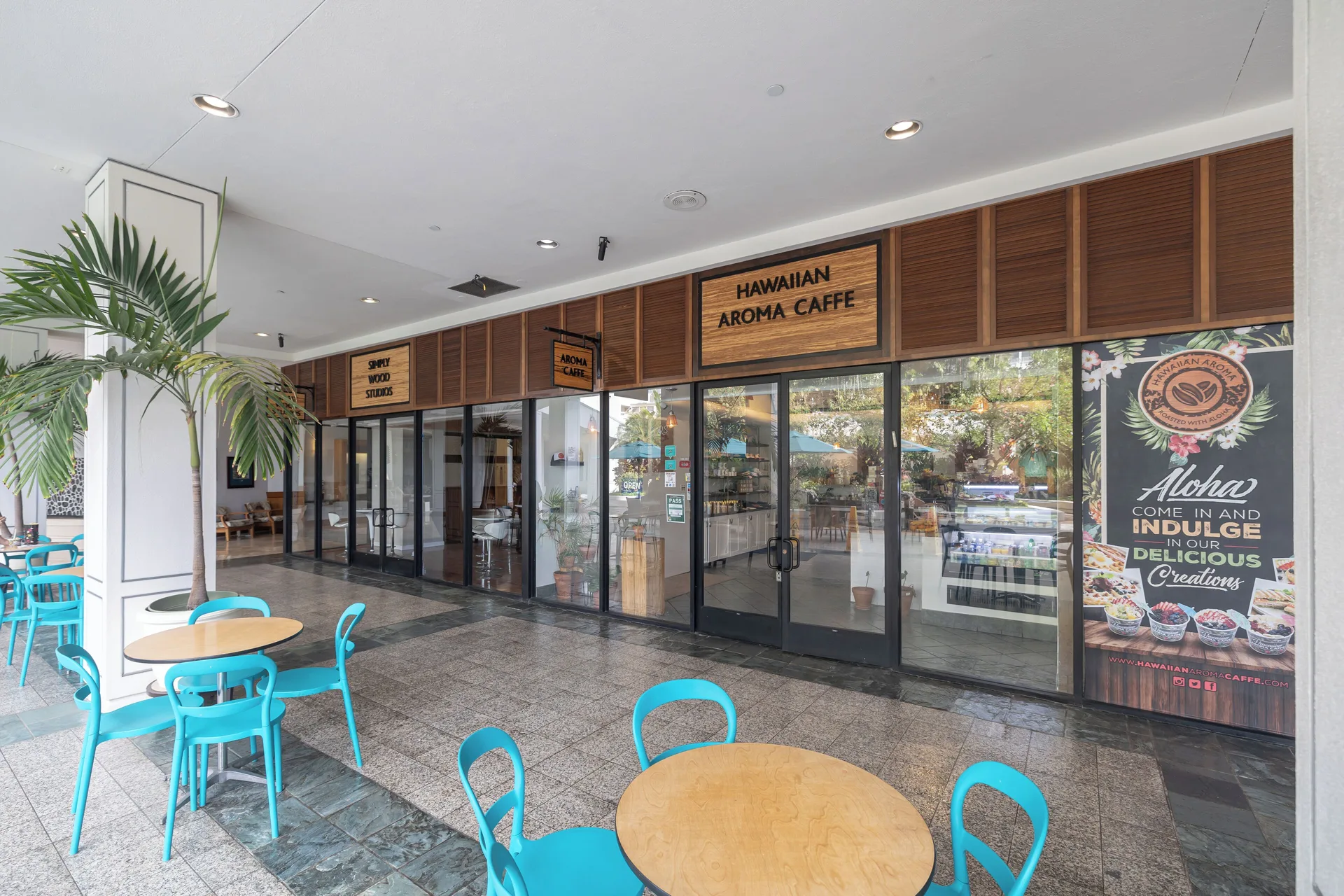 Hawaiian Aroma Caffé storefront and turquoise patio seating at Ilikai Hotel.