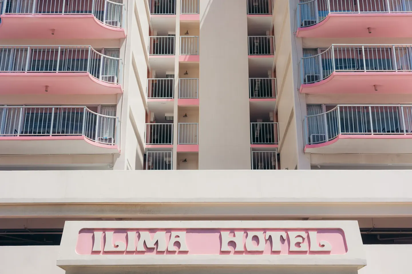 Exterior balconies and entrance sign on the Ilima Hotel facade.