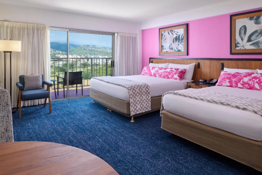 Deluxe Studio with two beds, balcony, and mountain view at Ilima Hotel.