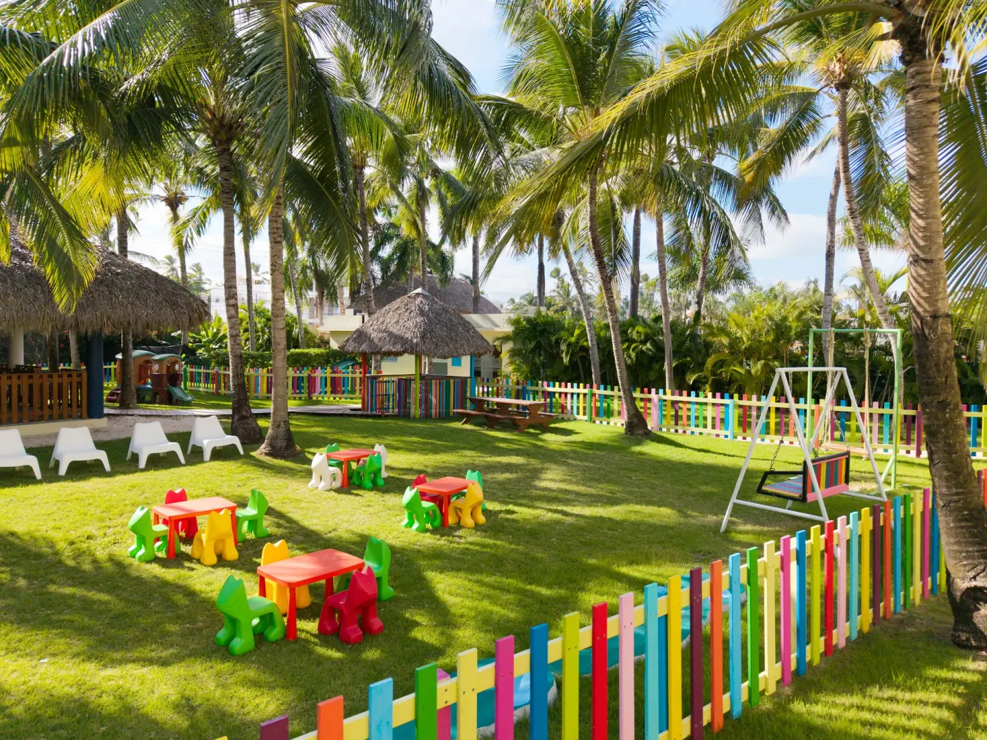 Colorful fenced children’s play area at Impressive Premium Punta Cana.