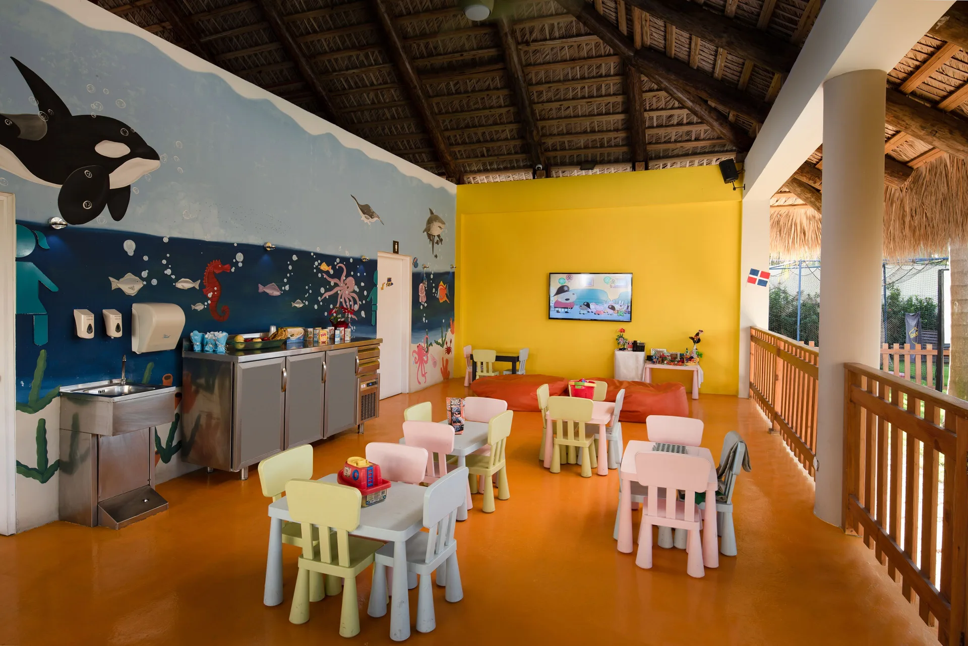Children's playroom with ocean murals and small tables at Impressive Premium Punta Cana.