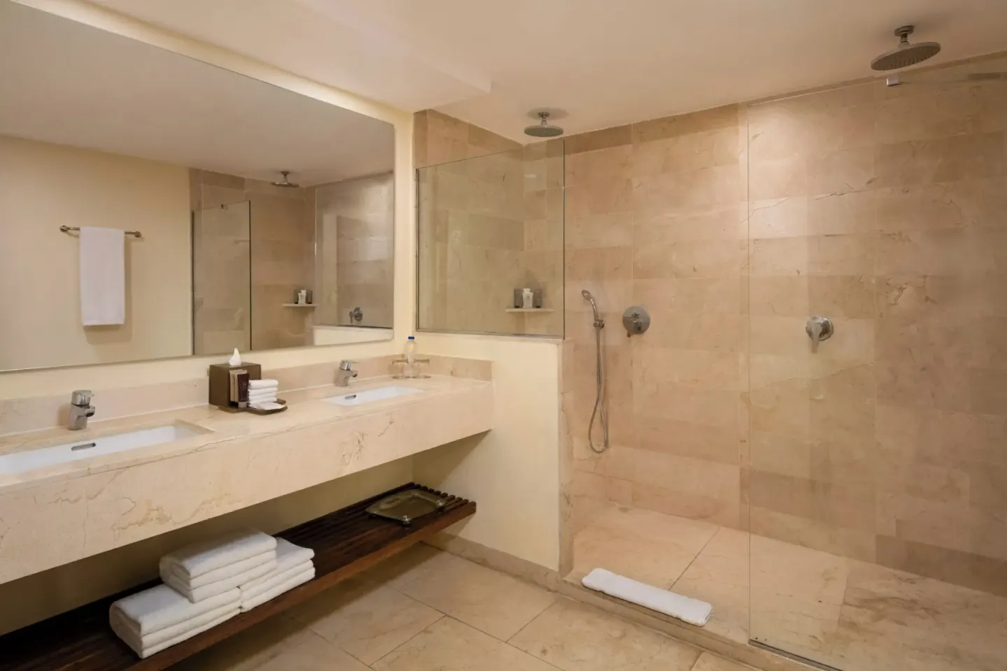 Guest bathroom with double vanity and walk-in shower at Impressive Premium Punta Cana.