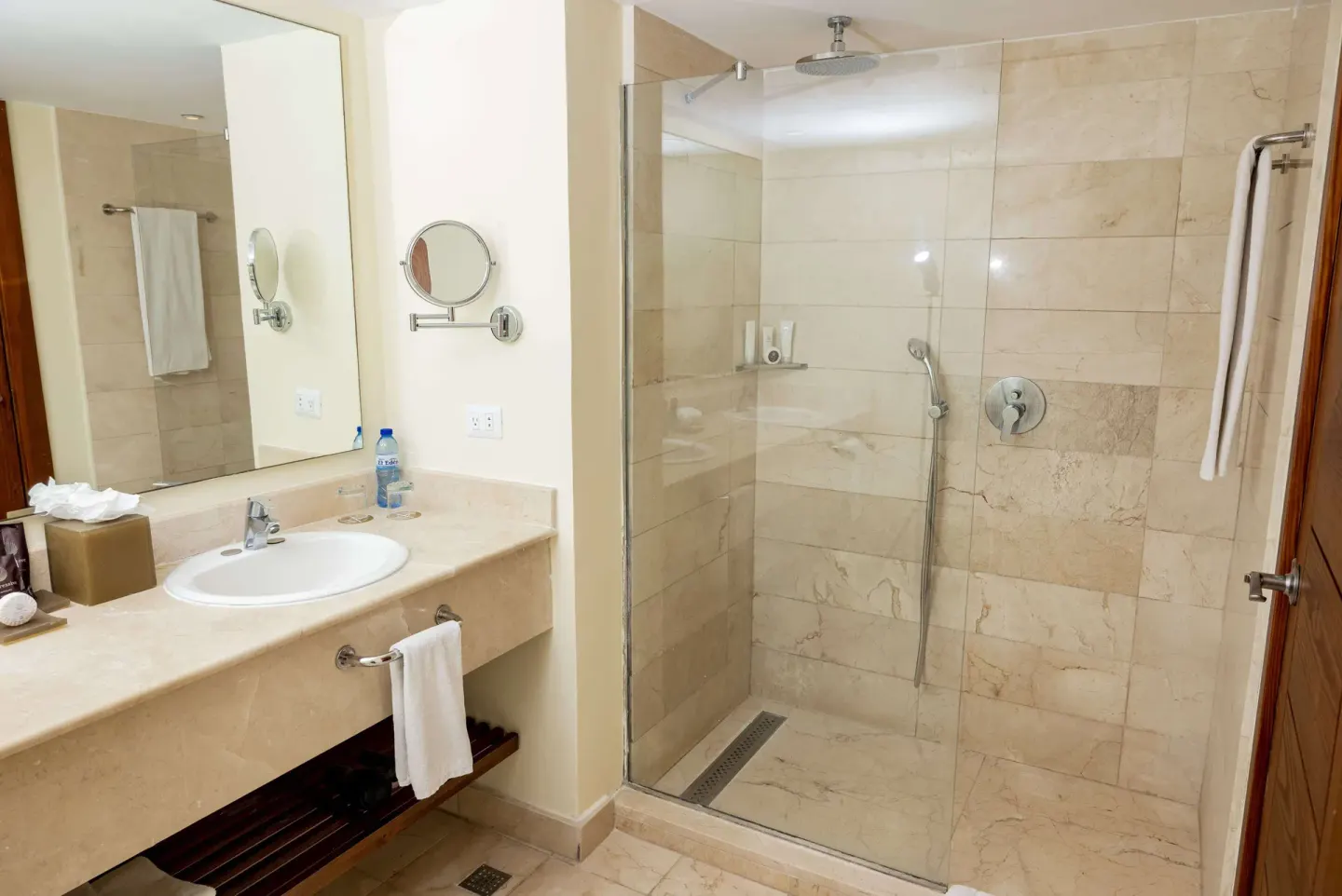 Guest bathroom with glass shower and vanity at Impressive Premium Punta Cana.
