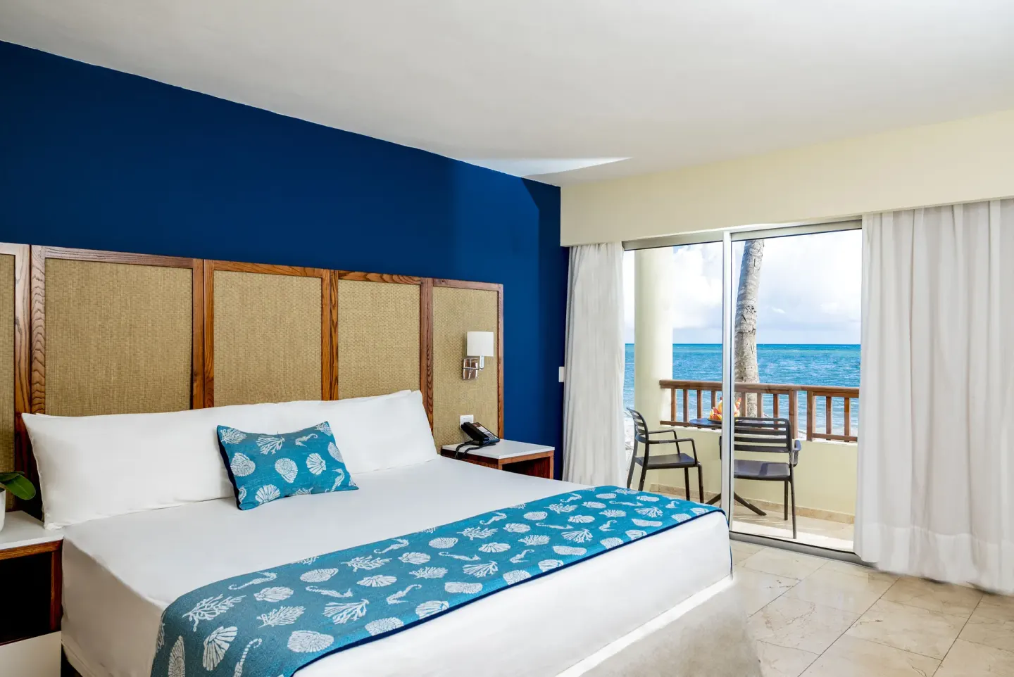 Ocean-view guest room with king bed at Impressive Premium Punta Cana.