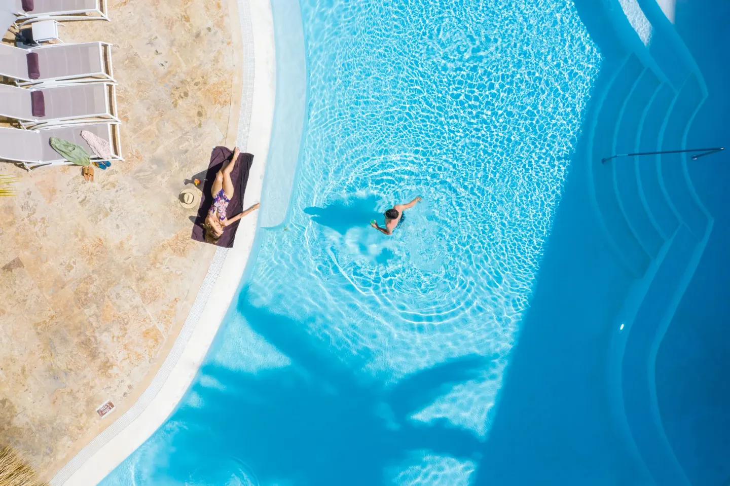Overhead view of guests by a bright blue pool at Impressive Premium Punta Cana.