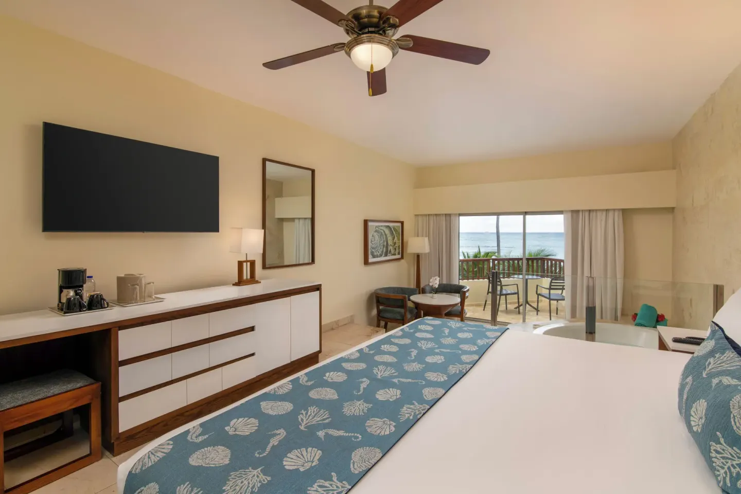 Oceanfront junior suite king bed with TV, balcony and tub at Impressive Premium Punta Cana.