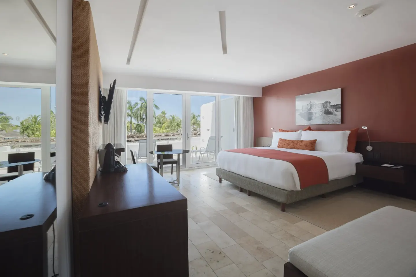 King guest room with balcony and palm views at InterContinental Presidente Cancun Resort.