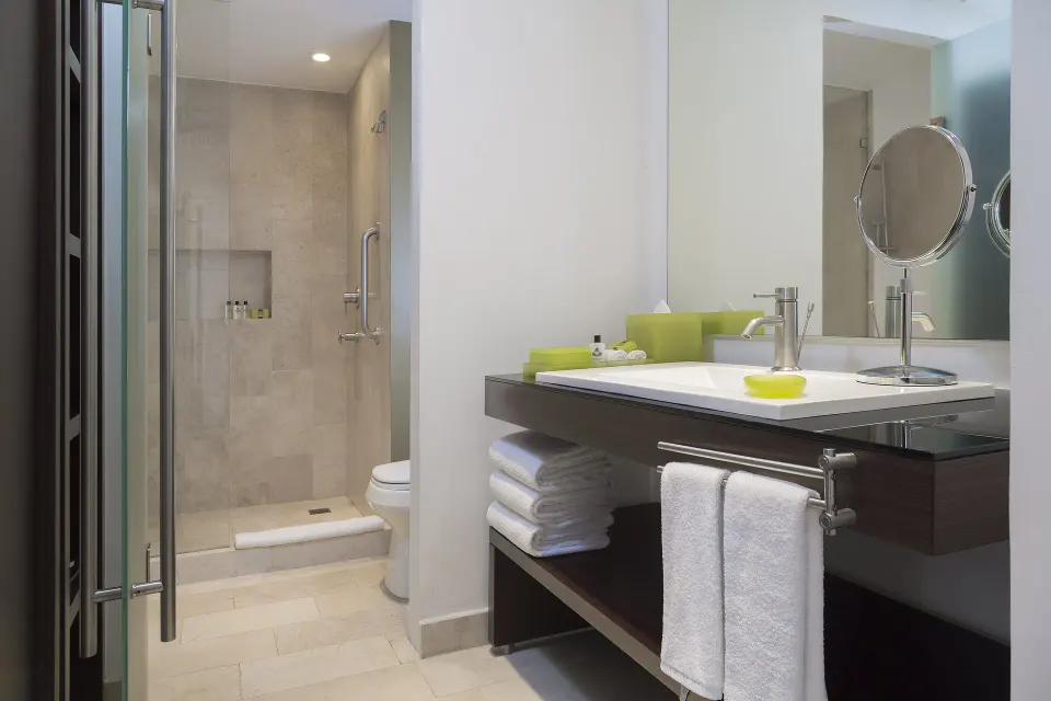 Bathroom vanity and walk-in shower at InterContinental Presidente Cancun Resort.