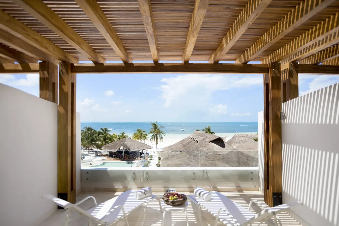 Balcony terrace with loungers and beach view at InterContinental Presidente Cancun Resort.