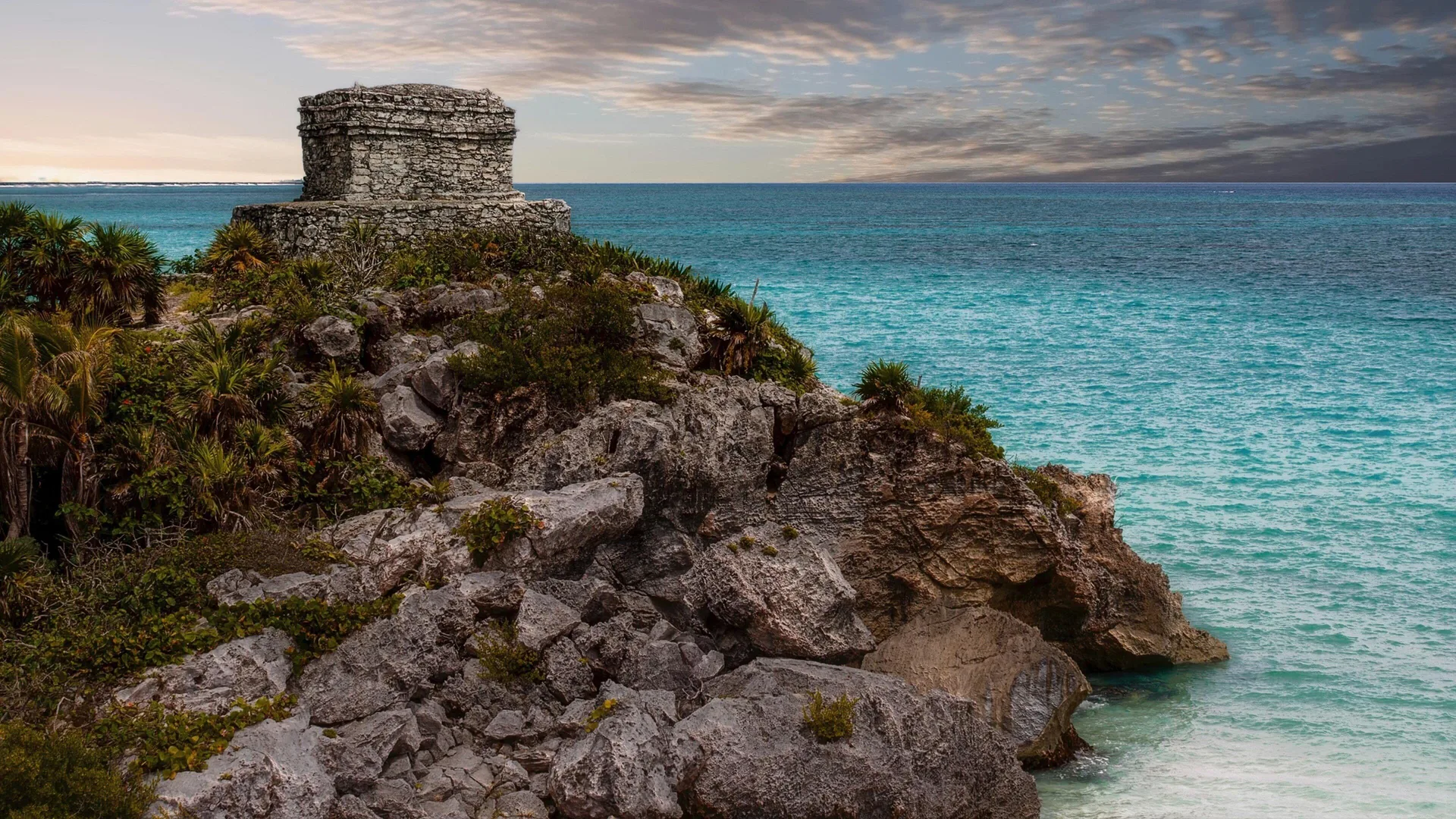Coastal ruins and turquoise sea near InterContinental Presidente Cancun Resort.