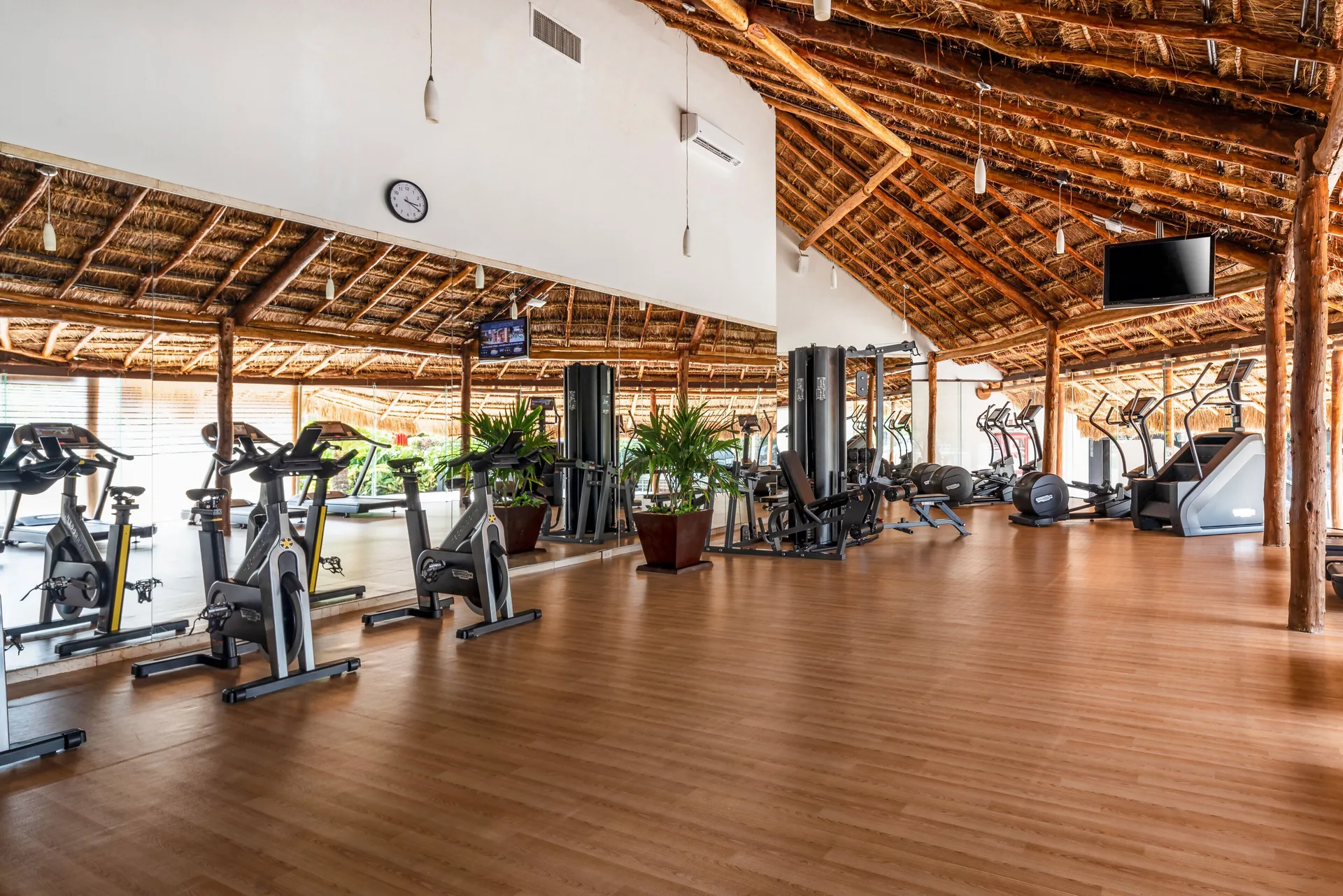 Spacious gym with bikes, weight machines, and mirrors at InterContinental Presidente Cancun Resort.