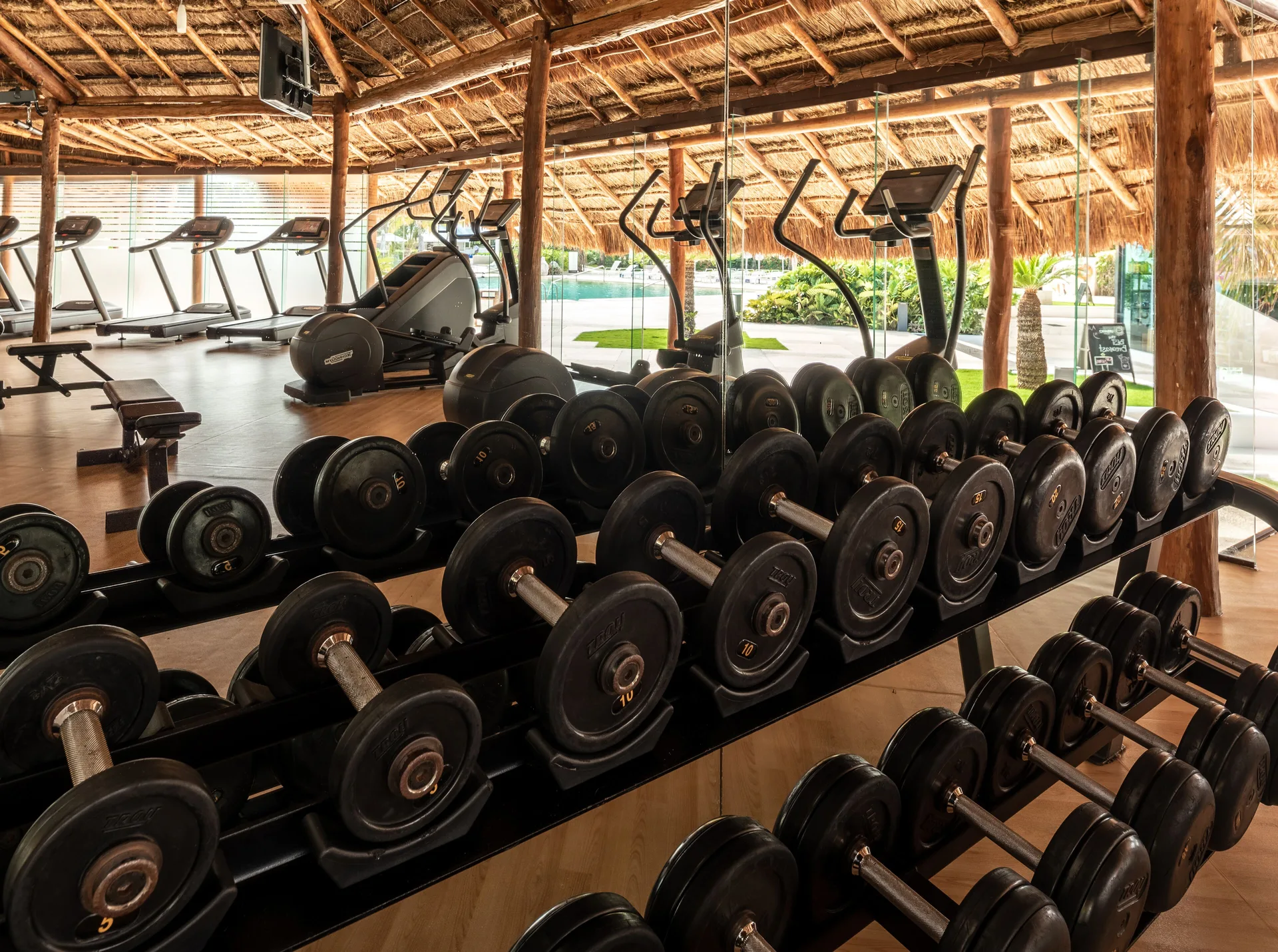 Fitness center dumbbells and cardio machines at InterContinental Presidente Cancun Resort.