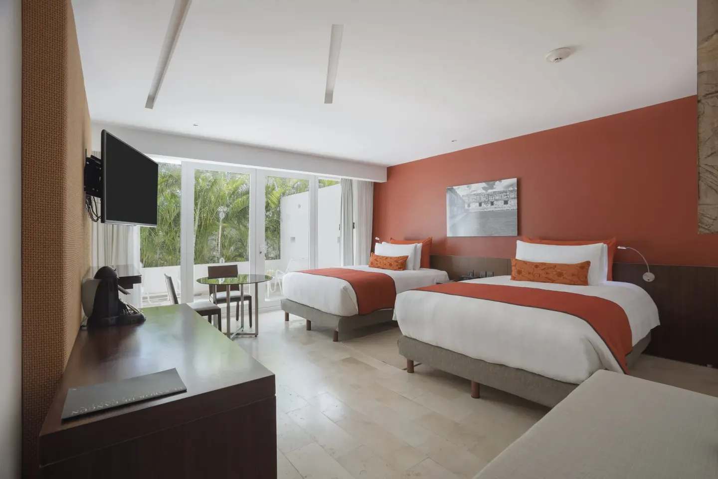 Two-bed guest room with garden-facing glass doors at InterContinental Presidente Cancun Resort.