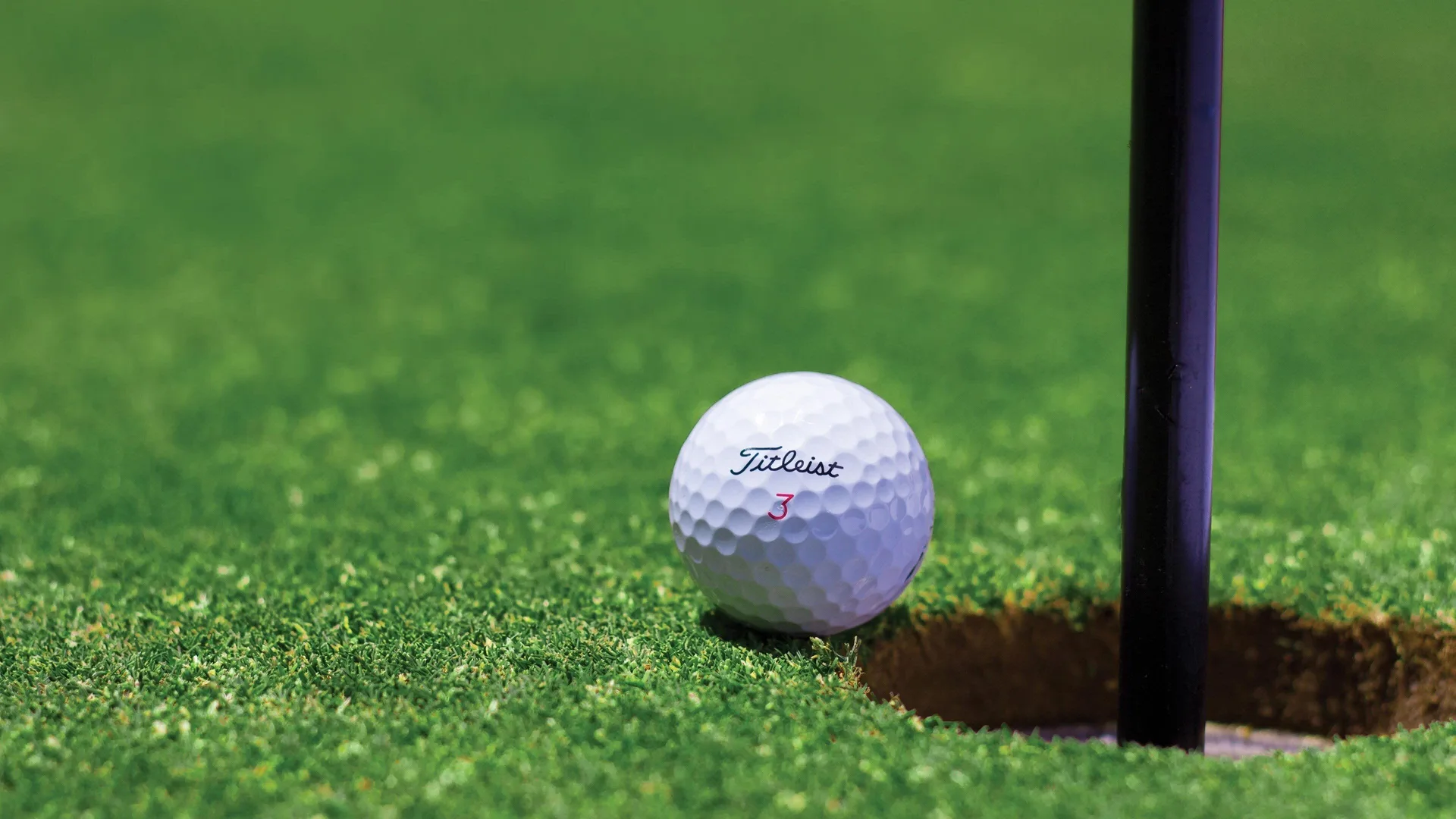 Golf ball beside a hole near InterContinental Presidente Cancun Resort.