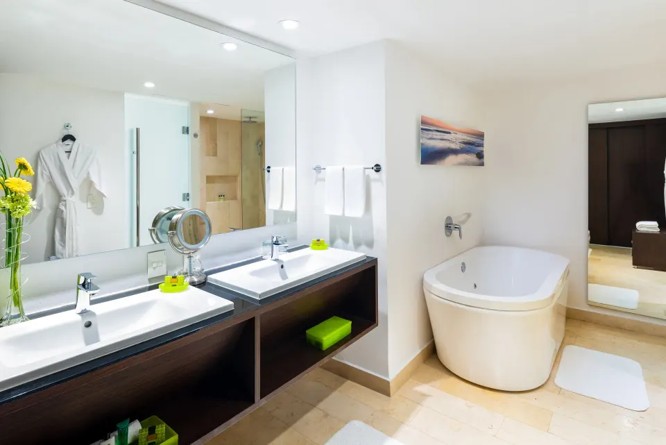 Guest bathroom with double sinks and soaking tub at InterContinental Presidente Cancun Resort.