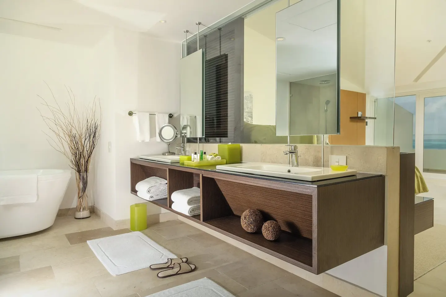 Guest bathroom with double vanity and freestanding tub at InterContinental Presidente Cancun Resort.