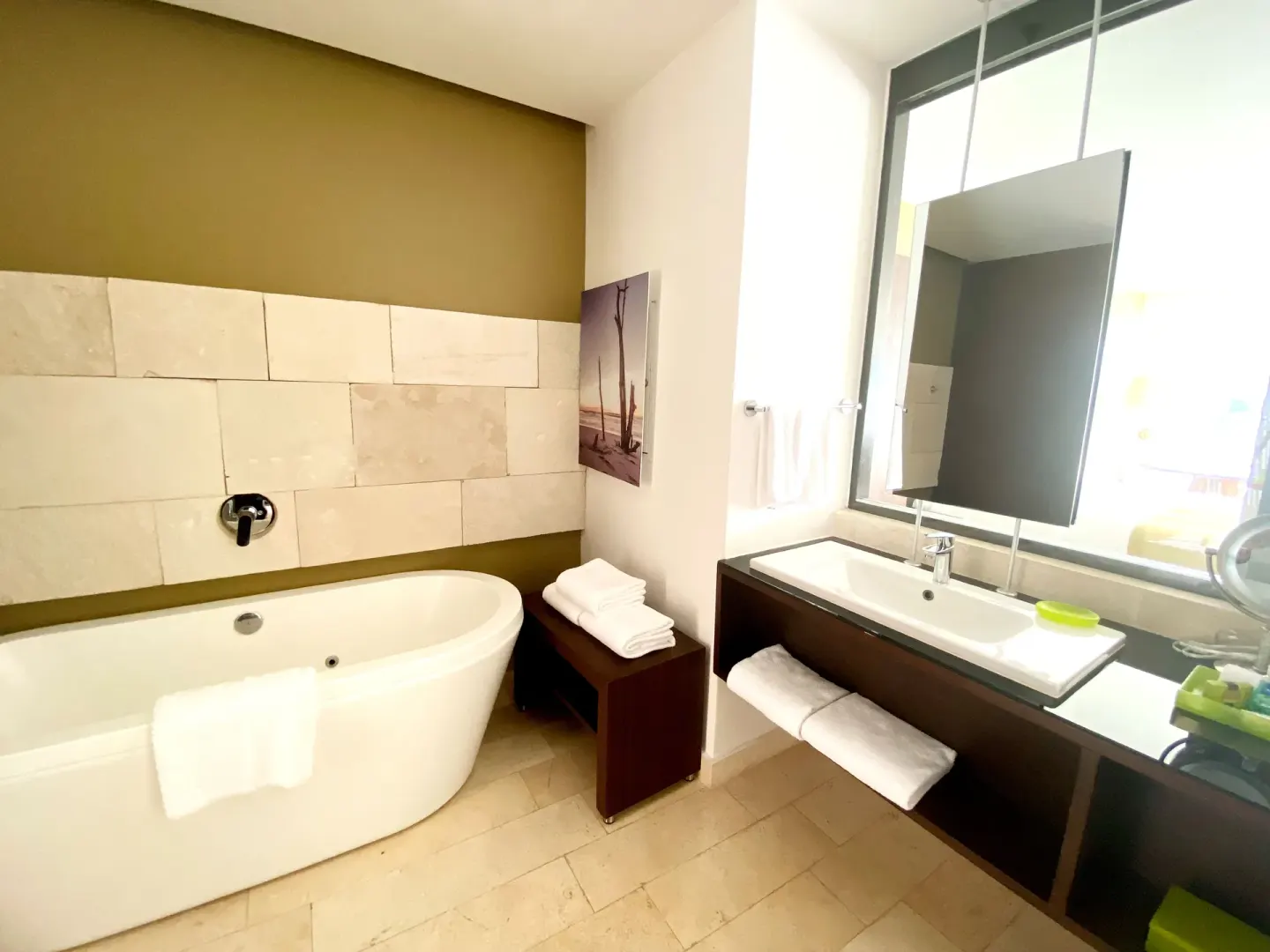 Guest bathroom with oval tub and single vanity at InterContinental Presidente Cancun Resort.