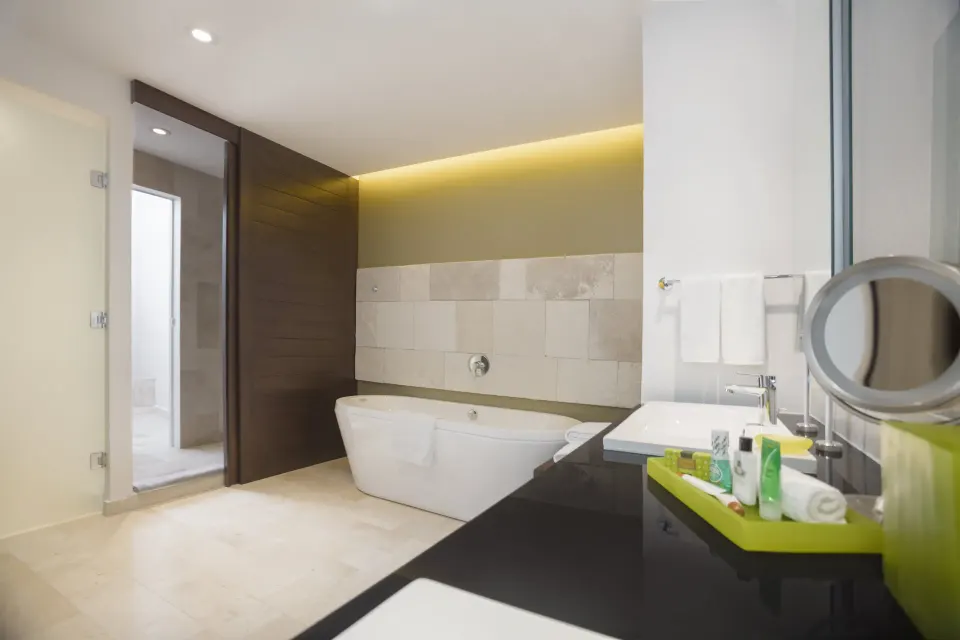Guest bathroom tub and vanity amenities at InterContinental Presidente Cancun Resort.