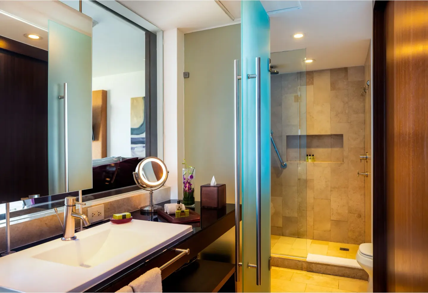 Guest bathroom vanity and glass shower at InterContinental Presidente Cancun Resort.