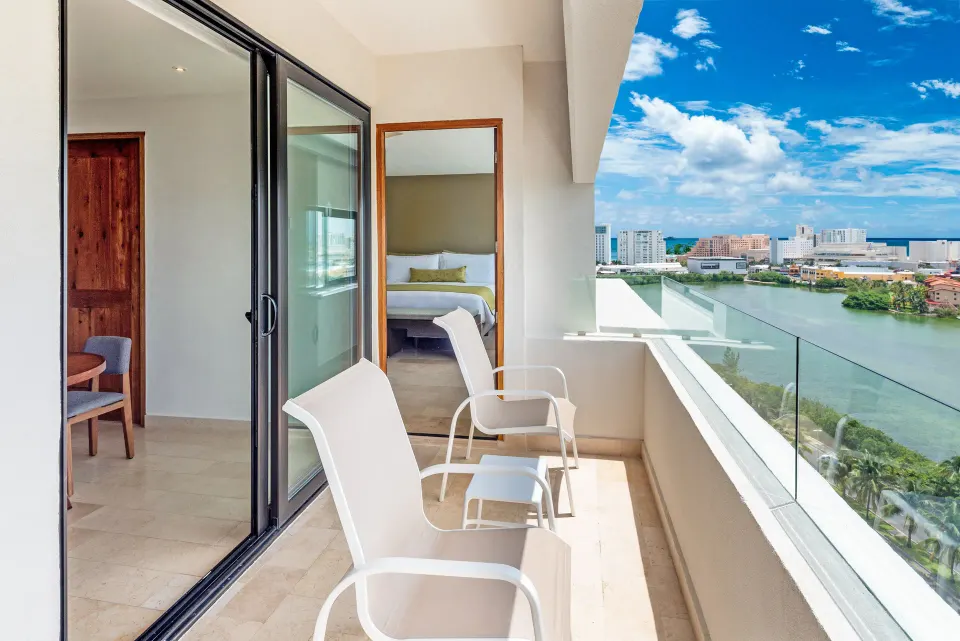 Balcony with chairs and lagoon view at InterContinental Presidente Cancun Resort.