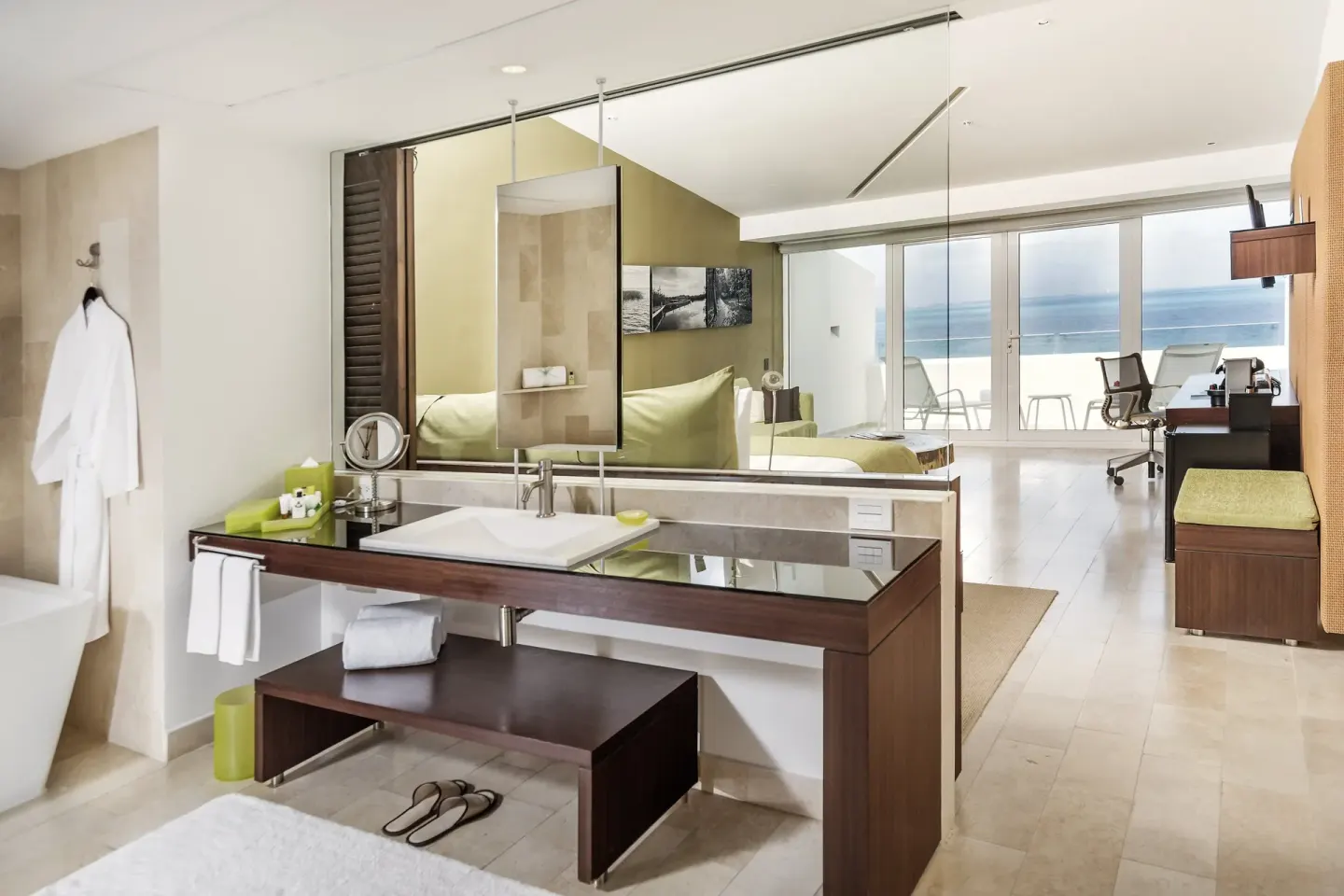 Open guest room bathroom and ocean-facing balcony at InterContinental Presidente Cancun Resort.