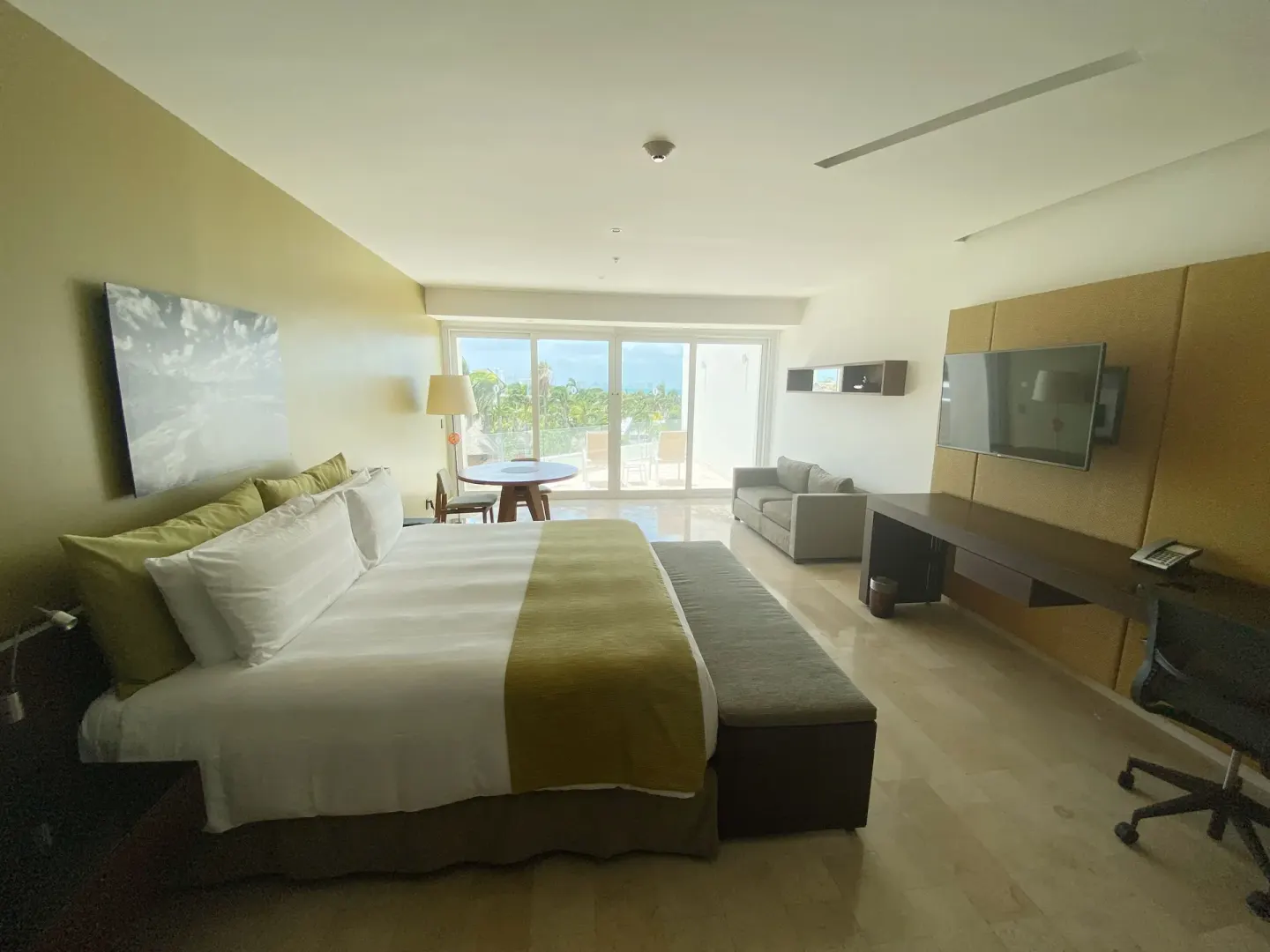 King bed guest room with balcony doors at InterContinental Presidente Cancun Resort.