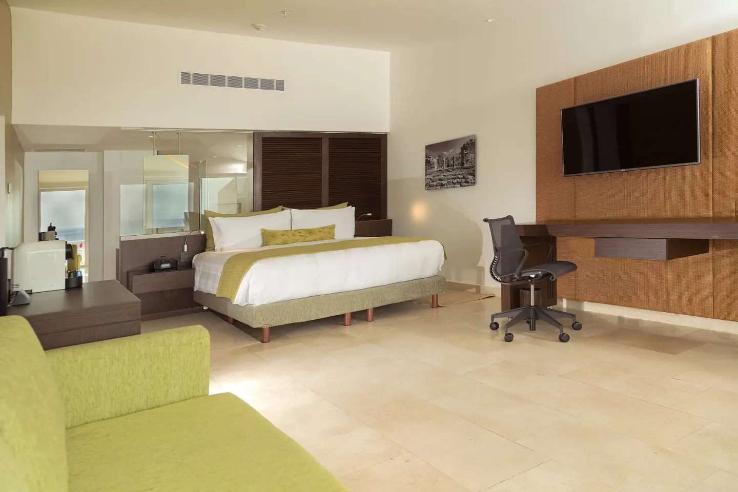 King bed guest room with desk and wall-mounted TV at InterContinental Presidente Cancun Resort.