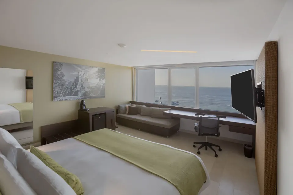 Ocean-view guest room with king bed and desk at InterContinental Presidente Cancun Resort.