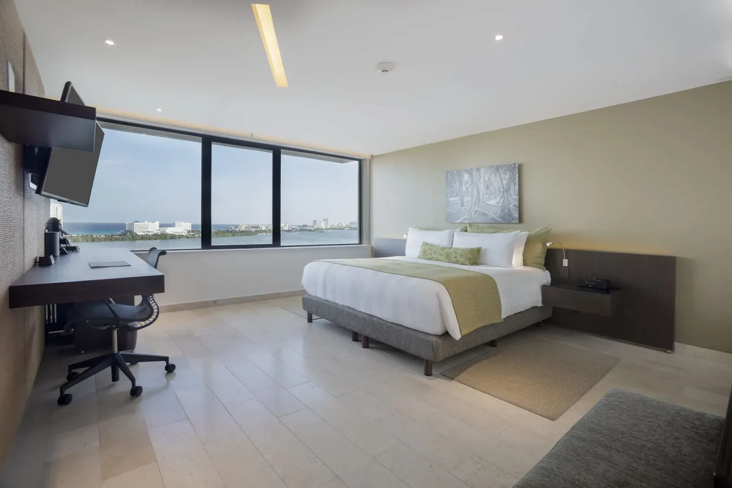 King bed guest room with wide lagoon view at InterContinental Presidente Cancun Resort.