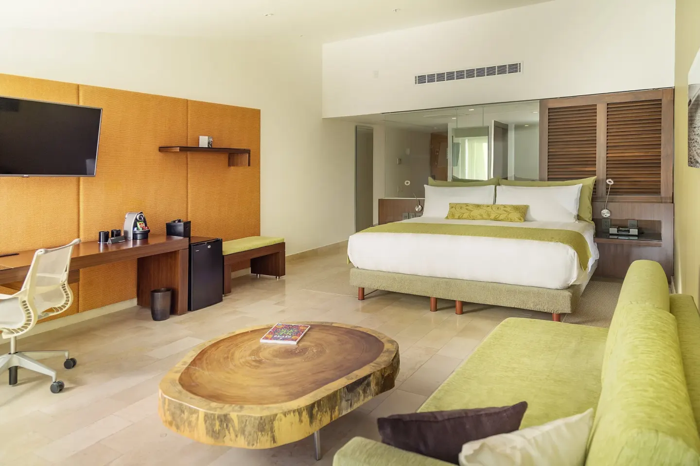 King guest room with sofa and wood-slab coffee table at InterContinental Presidente Cancun Resort.