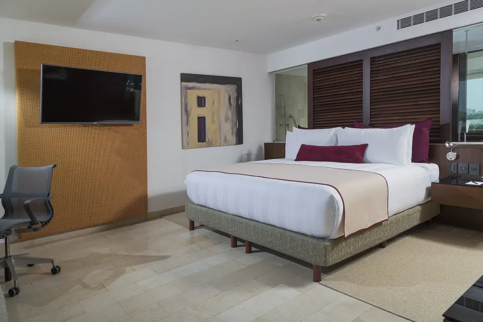 King guest room with TV and work chair at InterContinental Presidente Cancun Resort.