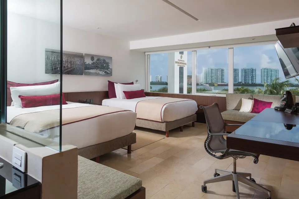 Two-bed guest room with lagoon-facing windows at InterContinental Presidente Cancun Resort.