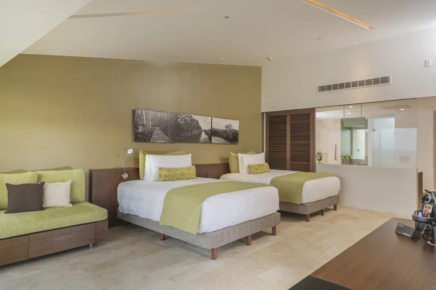 Two-bed guest room with lounge seating at InterContinental Presidente Cancun Resort.