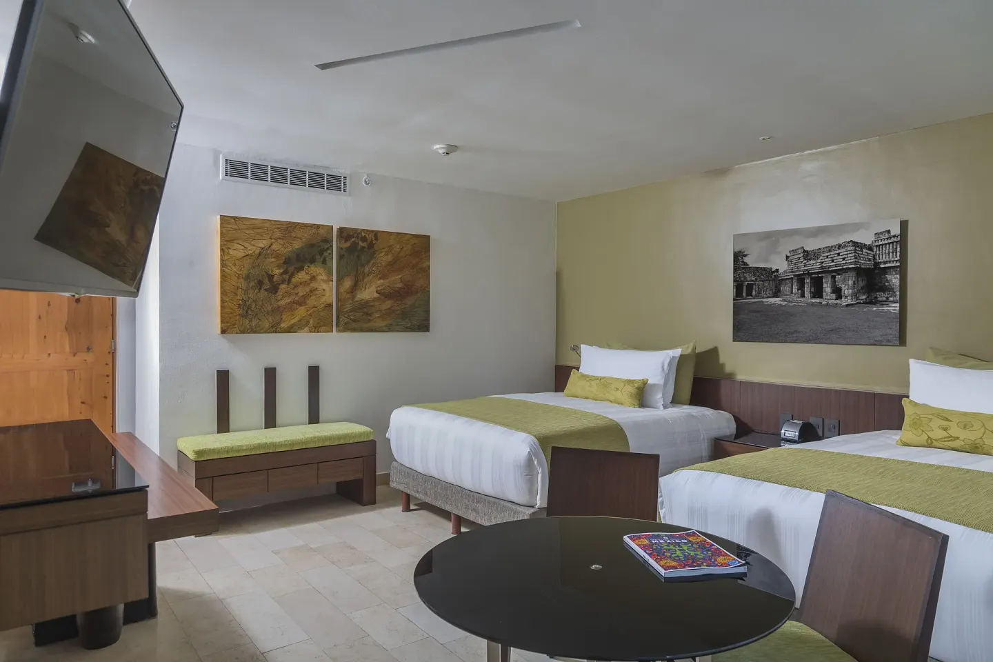 Two-bed guest room with round table at InterContinental Presidente Cancun Resort.