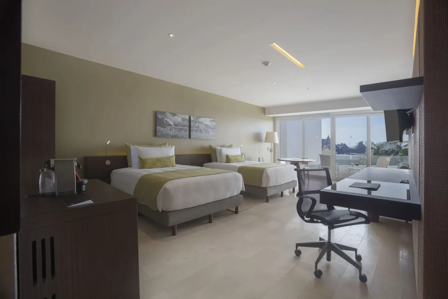 Double-bed guest room with work desk and balcony doors at InterContinental Presidente Cancun Resort.