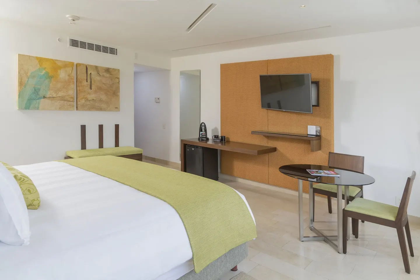 King guest room with dining table and work area at InterContinental Presidente Cancun Resort.