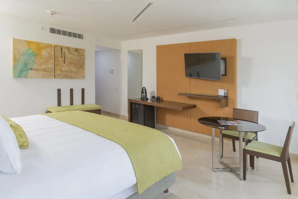 King guest room with dining table and work area at InterContinental Presidente Cancun Resort.