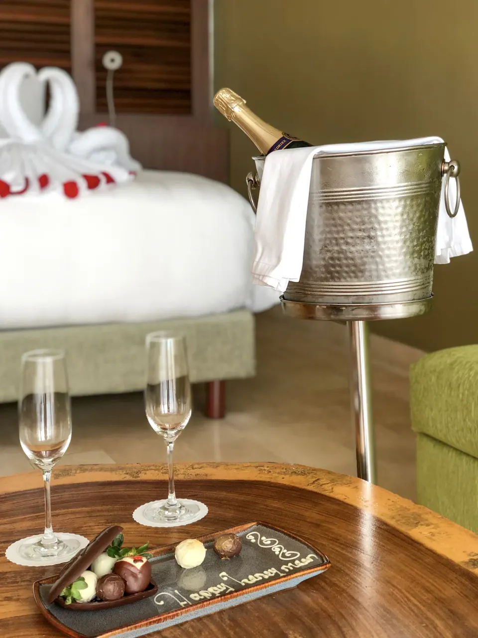 In-room welcome setup with sparkling wine, glasses and chocolates at InterContinental Presidente Cancun Resort.