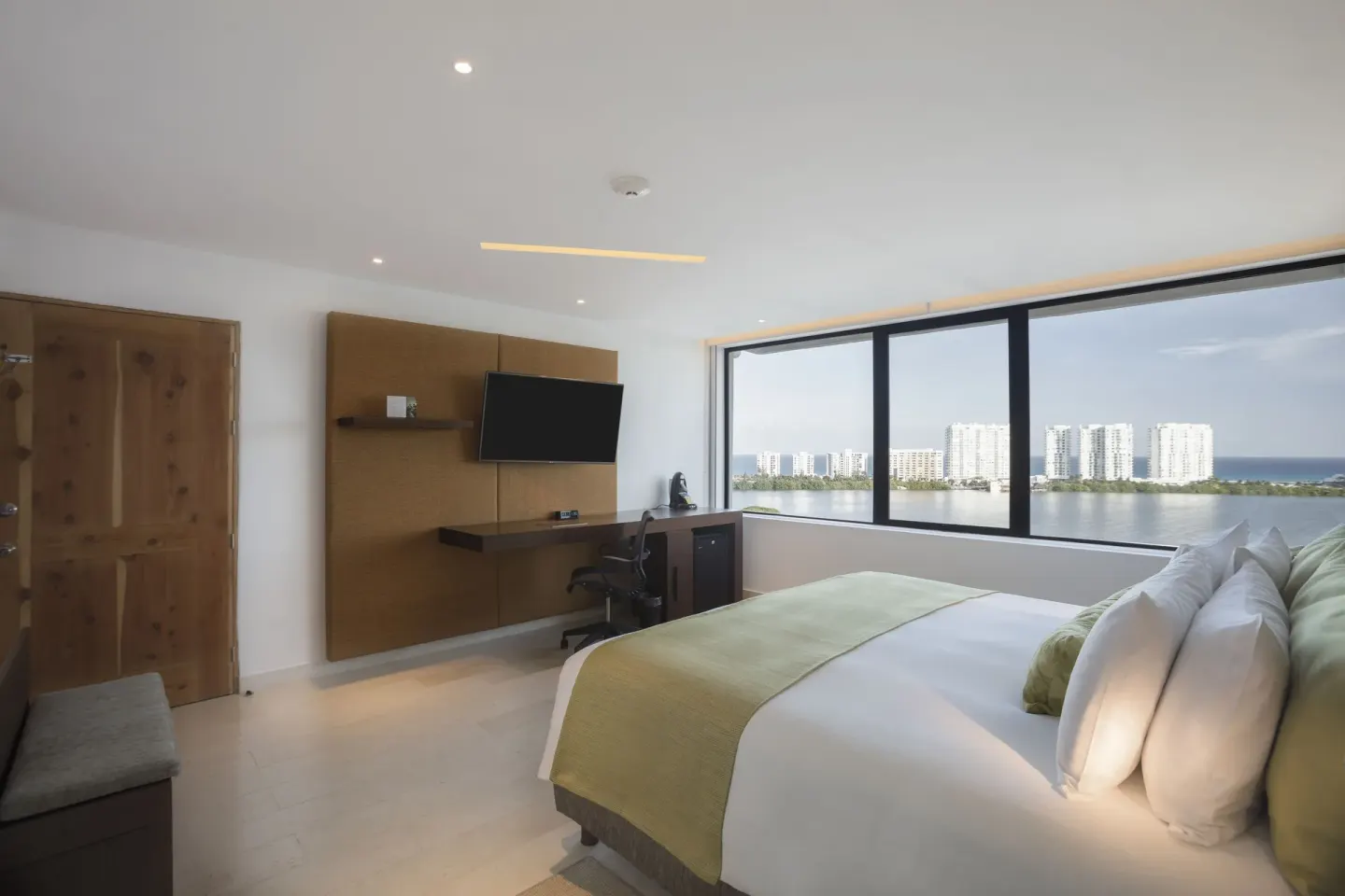 King bed guest room with lagoon and skyline view at InterContinental Presidente Cancun Resort.