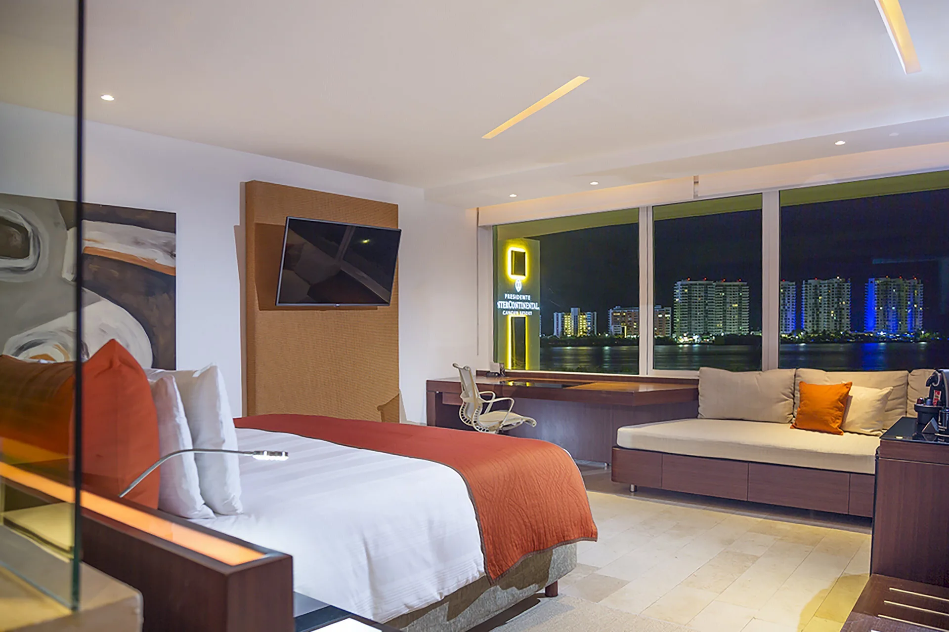King bed room at night with lagoon view at InterContinental Presidente Cancun Resort.