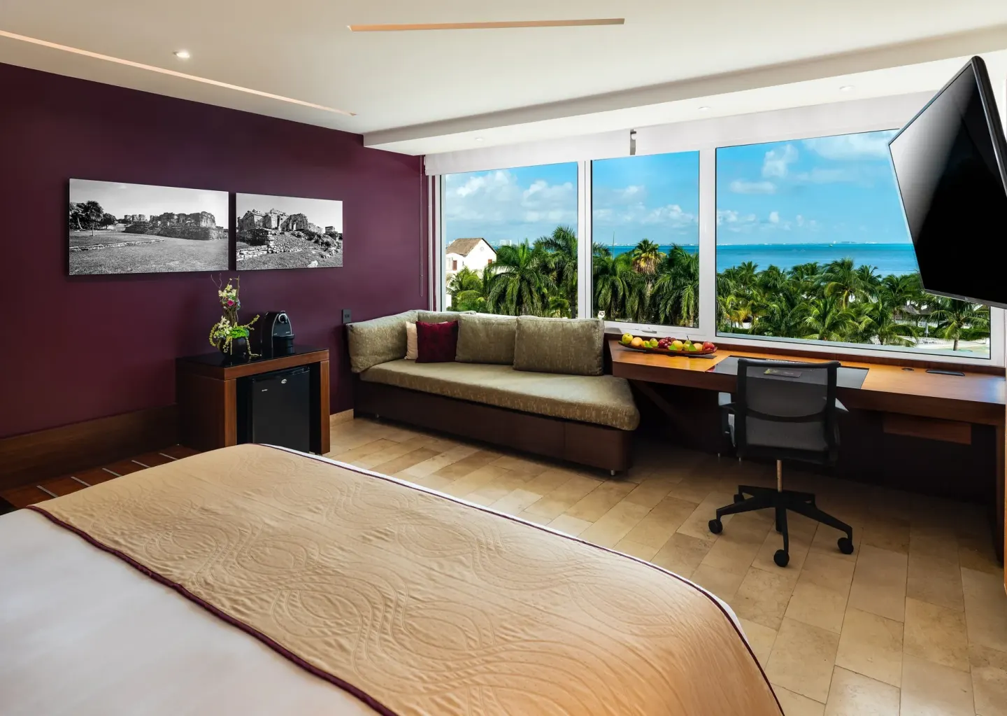 King bed room with sofa, desk, and ocean view at InterContinental Presidente Cancun Resort.