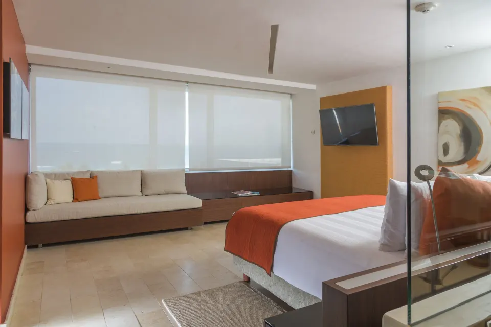 King guest room with sofa and filtered ocean view at InterContinental Presidente Cancun Resort.