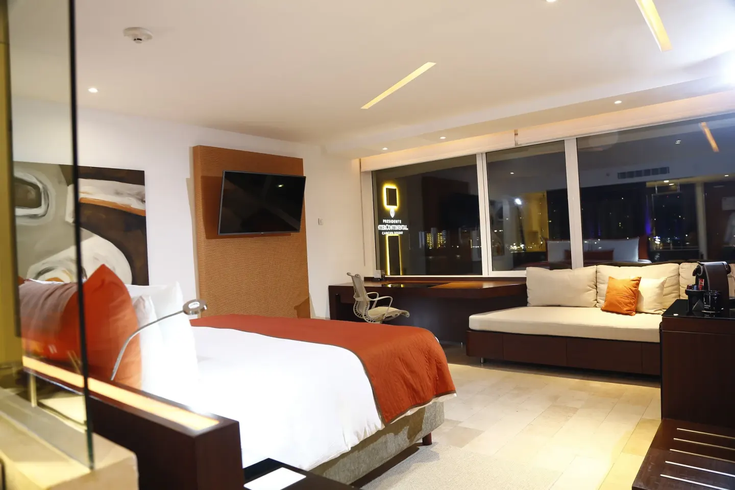King guest room with sofa and night view at InterContinental Presidente Cancun Resort.