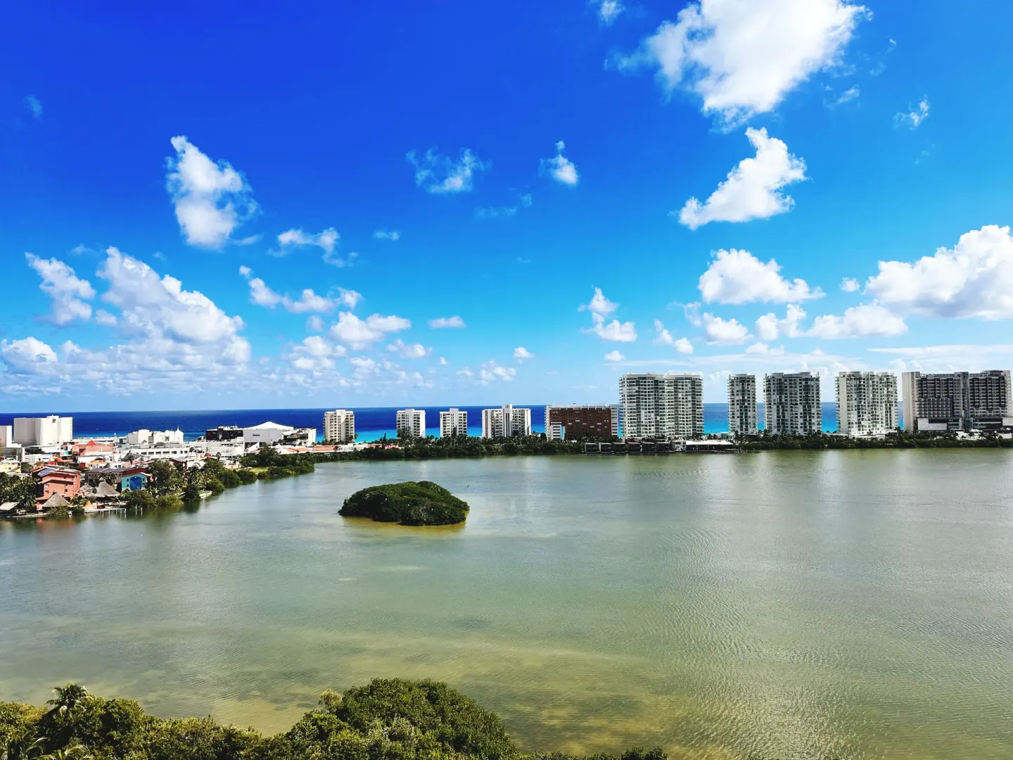 Lagoon, skyline, and Caribbean water near InterContinental Presidente Cancun Resort.