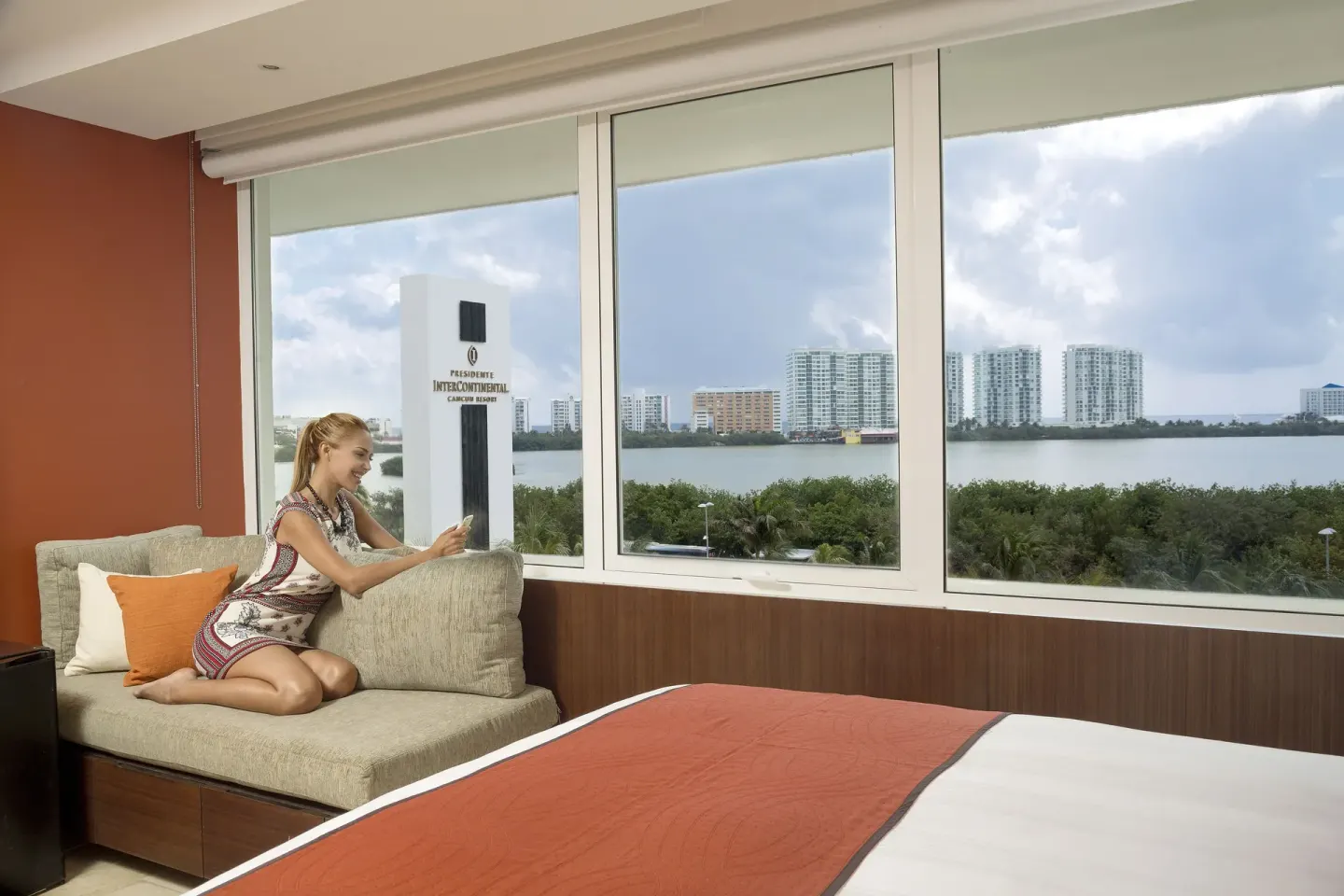 Lagoon-view guest room with window sofa at InterContinental Presidente Cancun Resort.
