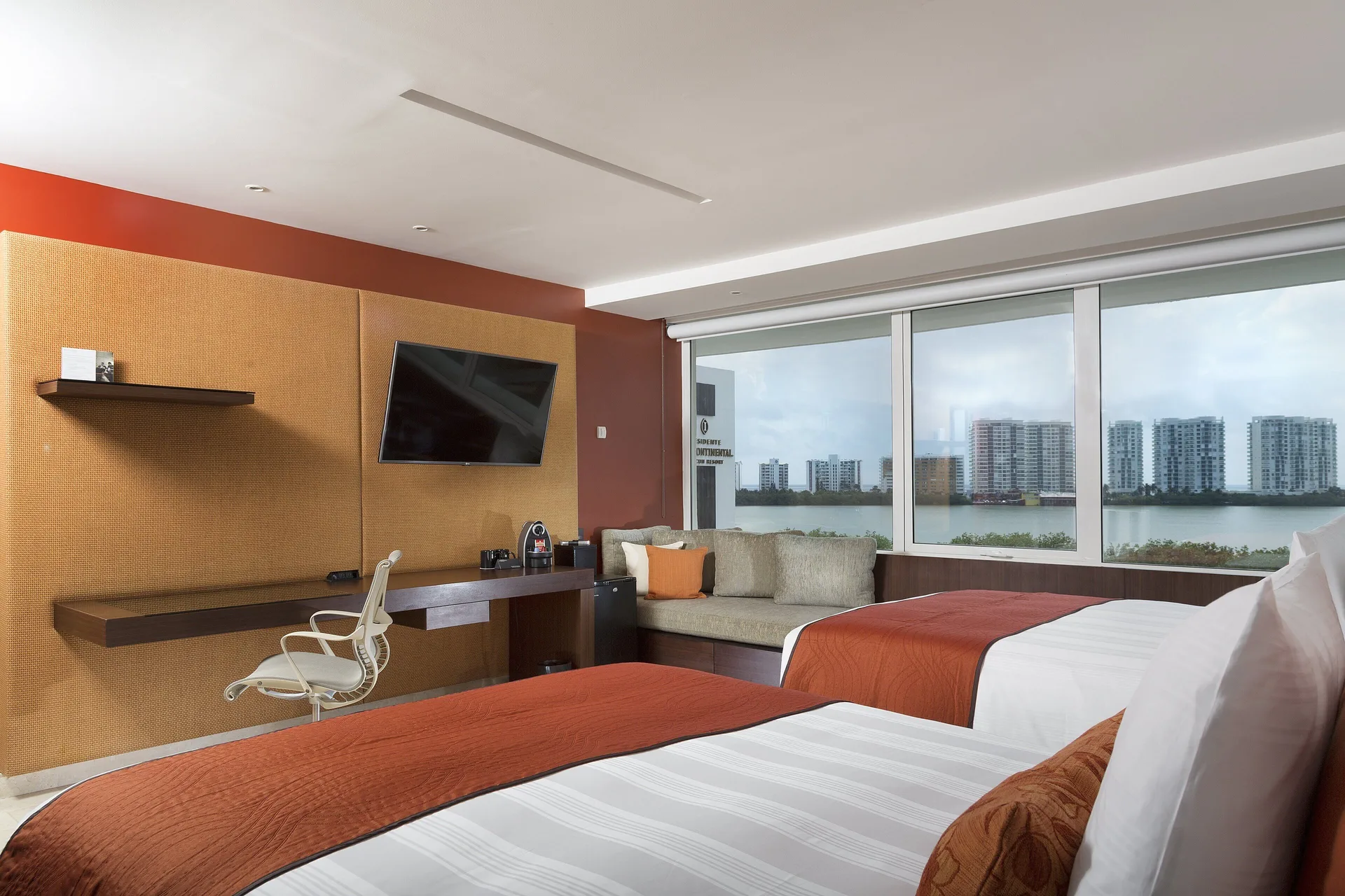 Two-bed guest room with lagoon and skyline views at InterContinental Presidente Cancun Resort.