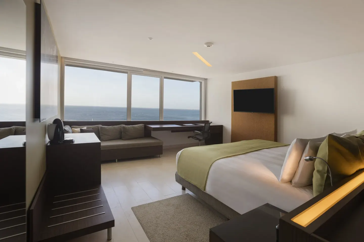 Ocean-view guest room with king bed at InterContinental Presidente Cancun Resort.